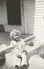 Lois Van Pelt sitting on porch step, Mar 1942, Glendale, CA